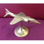 A brass Harrier aeroplane on a stand approx 12cm high.