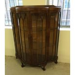 A bow fronted mahogany display cabinet approx 107cm wide x 127cm tall with 2 keys and ball & claw