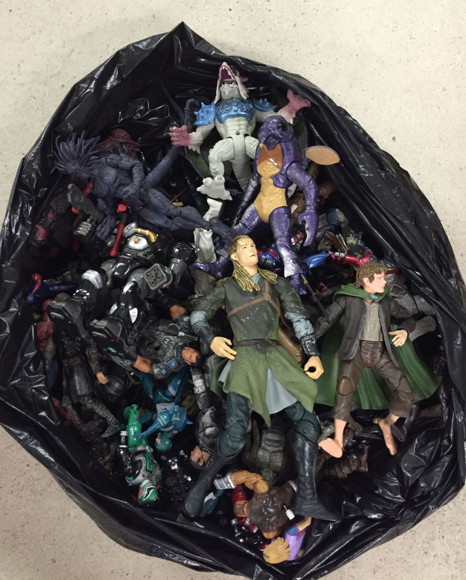 A large collection of Action figures to include Spider-man, Lord of the Rings and Gears of War.