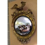 Vintage convex mirror with gilt eagle decoration (a/f), 92cm x 60cm.