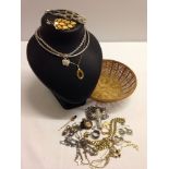 A small basket of vintage and modern costume jewellery.
