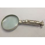 A silver plate magnifying glass with golf bag handle.