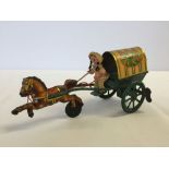 A c1950s tinplate wind-up covered wagon.