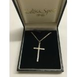 An engraved silver cross, approx 3cm x 2cm, on a silver chain.