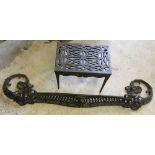 A cast iron ornate fire fender approx 122cm across external width, together with a cast iron stand