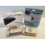 A boxed Nintendo DS Lite with soft case, extra pack & 2 boxed games.