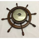 A ships wheel barometer.