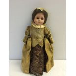 Vintage doll in period costume with composition head and stuffed soft body.