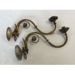 A pair of decorative brass wall light fittings.