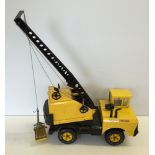 A Tonka tinplate mobile crane with bucket grab.