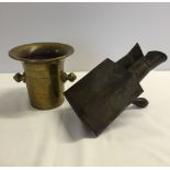 A heavy brass pot with an old picture viewer.