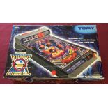 A boxed Tomy Atomic pinball machine.