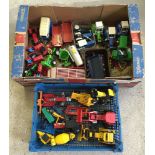 2 boxes of toy tractors and accessories.