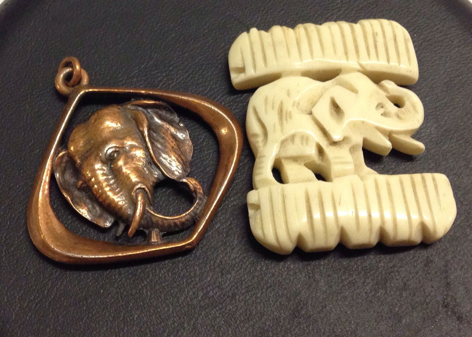 A carved bone elephant figure 3cm x 4cm, together with a vintage 3D copper elephant pendant,