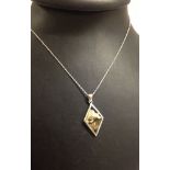 Silver diamond shaped pendant set with mother of pearl/shell. On an 18" silver chain.
