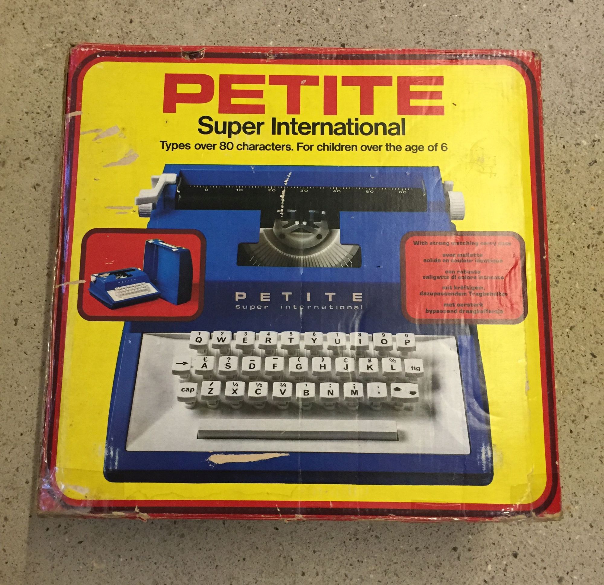 A boxed Petite Super International child's typewriter.
