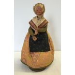 A vintage celluloid doll of a pedlar woman approx 30cm tall.