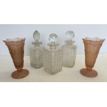 3 glass/crystal decanters together with a pair of moulded pink glass vases.