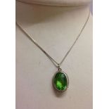 Large oval green kiwi topaz stone pendant on a 16" silver chain.