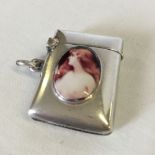 A silver vesta case with enamelled plaque of a nude lady (hallmarked Birmingham 1901).