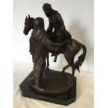 A very large bronze sculpture of a horse and Arab man & lady (approx 30cm wide x 44cm high).