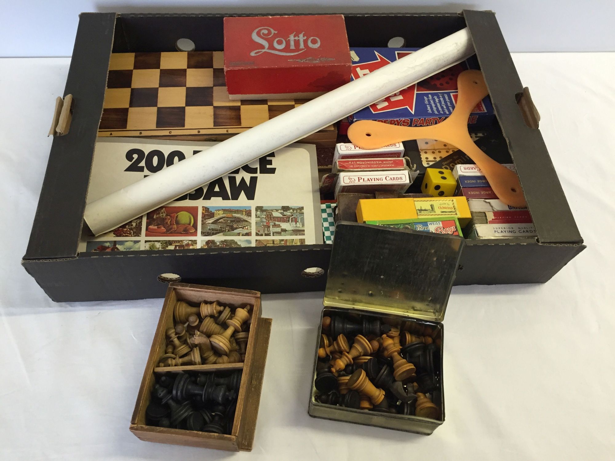 A box of vintage and modern games and playing cards. To include wooden chess pieces and Lotoo game.