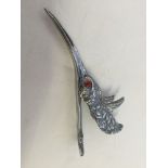 A large paper clip of a birds head and beak (approx 13cm long).