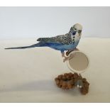 A decorative figure of a Budgerigar.