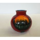 A small round red, orange & blue glazed Poole Pottery vase approx 10cm tall.