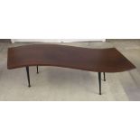 A 1960s wave top wooden coffee table with screw in legs.