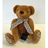 A Burberry teddy bear in 'as new' condition with label.