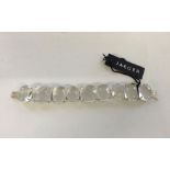 Jaeger bracelet with large clear polished and cut stones set in silvertone mounts. With original