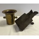 A heavy brass mortar with an old picture viewer.