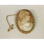 A large cameo brooch with safety chain set in 9ct gold mount measuring 3.5cm x 4.5 cm