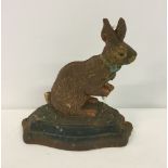A cast iron painted doorstop in the shape of a rabbit, approx 21cm tall