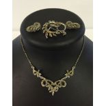 A marcasite necklace together with a brooch and a pair of clip on earrings