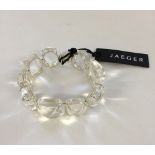 Jaeger bracelet with large clear polished and cut stones set in silvertone mounts. With original