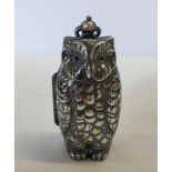 A owl shaped metal sovereign case.