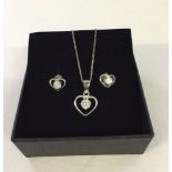 A 925 silver heart shaped pendant set with cubic zirconia on chain together with matching earrings.