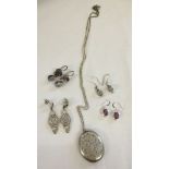 4 pairs of drop earrings together with a silver plated locket on a 925 chain. Earrings set with