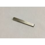 Hallmark silver tie bar with engine turned engraving.