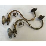 A pair of decorative brass wall light fittings.