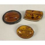 3 amber brooches, all set in 925 silver. 2 oval shaped, one square shaped.