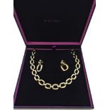 Large link goldtone necklace with matching clip on earrings in original box.