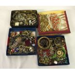 A tin box & 3 trays of vintage costume jewellery to include some designer.