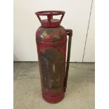 An old red fire extinguisher.