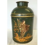 A green painted, lidded metal urn with fisherman design (approx 37cm high).