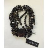 Statement necklace by Jaeger with 5 strings of beads in dark and silver tones. Large round