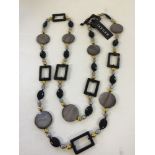 Stylish, long, Jaeger necklace with round, oval & rectangular beads. Has original label.