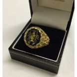 Gents 9ct gold ring set with engraved onyx stone, Size T, weight approx 7.9g.